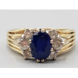 Ladies 14ct yellow gold blue and white stone cluster ring featuring an oval blue stone size R 3.9g