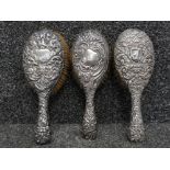 Three edwardian silver backed hair brushes of various designs