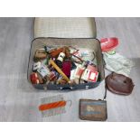 A vintage blue suitcase with contents to include leather belts and bags, cards, etc