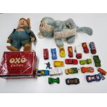 Chad Valley cat, snow white dwarf, and diecast toys in an Oxo tin