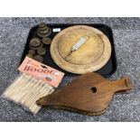 Tray lot of carved bread board, wooden dolly pegs, brass & steel weights, bellows an spring