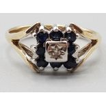 Ladies 9ct yellow gold square sapphire and diamond cluster ring featuring eight black sapphires size