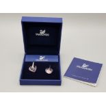 A pair of Swarovski silver and pink crystal heart shaped earrings with certificate, boxed.