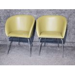 Pair of lime green leatherette tub chairs on chrome effect leg supports