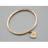 Michael Kors bracelet in rose gold style coloured metal with attached heart pendant