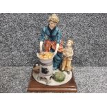 Capodimonte woman and child cooking pumpkin on the stove