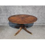 A circular walnut topped coffee table 100cm x 54cm