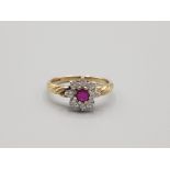 Ladies 9ct yellow gold ruby and diamond cluster ring comprising of a ruby set in the centre