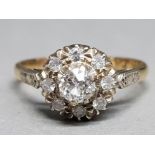 An 18ct yellow gold ans platinum diamond cluster ring size Q 3g gross