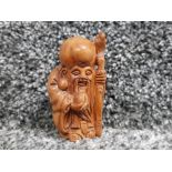 Hand carved hardwood netsuke depicting elder with staff