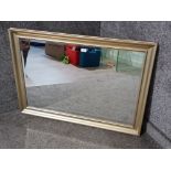 A modern bevelled wall mirror with silver/gold frame 72 x 101cm