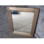 A modern bevelled wall mirror with detailing to corners 63 x 53cm