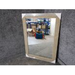 A modern bevelled wall mirror with stone effect frame 107 x 76cm