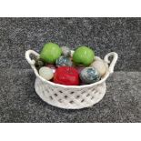 Twin handled porcelain bowl with basketwaeve design containing marble and onyx eggs glass apples