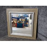 A modern square shaped wall mirror in gold and silver frame 58 x 58cm