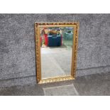 Ornate gilt framed bevel edged mirror