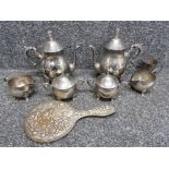 A pair of silver plated three piece tea sets, a silvet plated hand mirror and a nursery cup