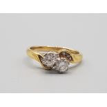 Ladies 18ct yellow gold 2 stone diamond ring featuring 2 brilliant round cut diamonds set on a twist