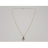 Ladies 9ct yellow gold garnet and cubic zirconia cluster pendant and chain featuring a oval garnet