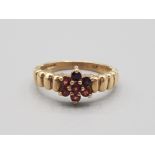 Ladies 9ct yellow gold garnet cluster ring comprising of 7 brilliant round cut garnet stones size