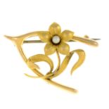 An early 20th century 15ct gold seed pearl floral wishbone brooch.Stamped 15ct.Length 3.2cms.