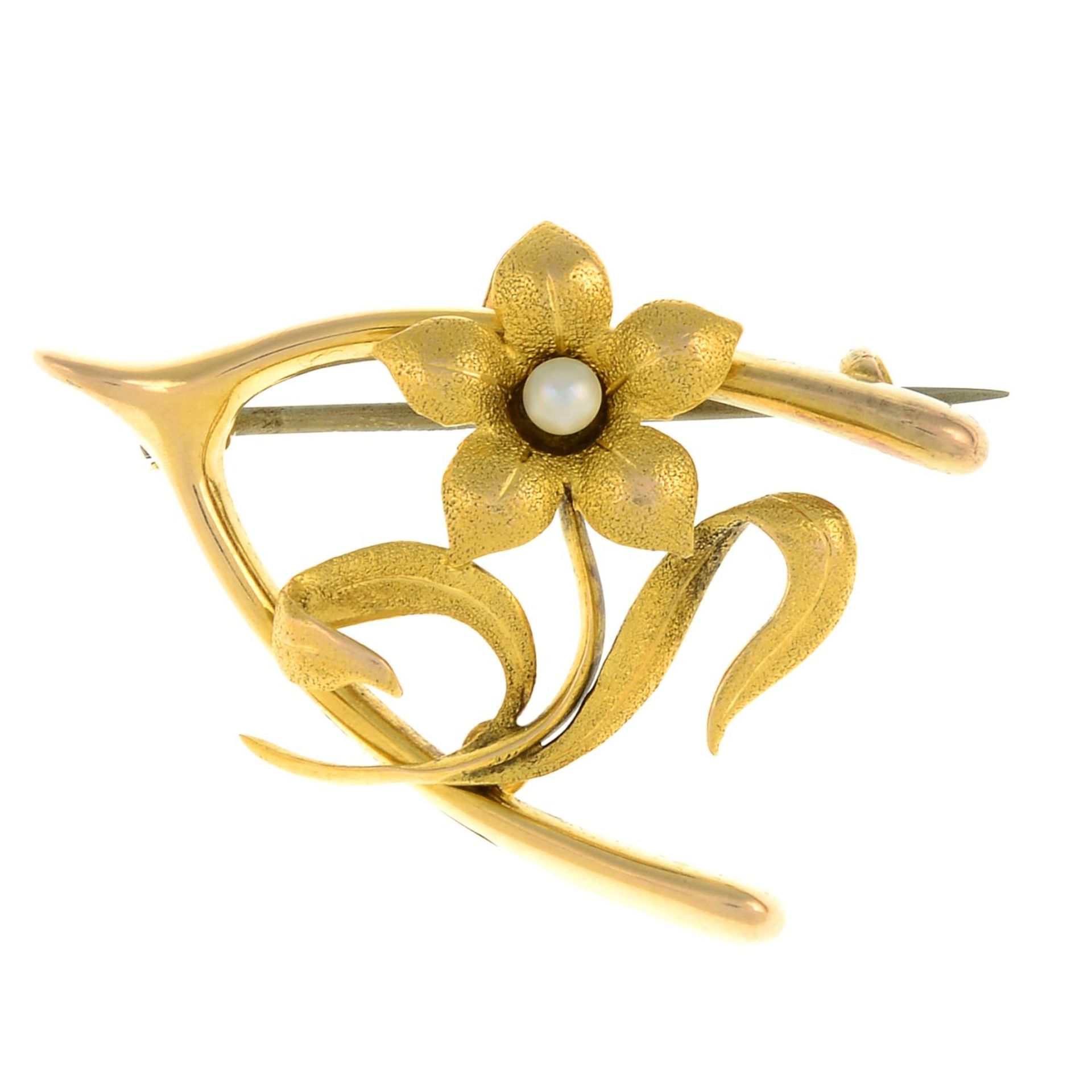 An early 20th century 15ct gold seed pearl floral wishbone brooch.Stamped 15ct.Length 3.2cms.