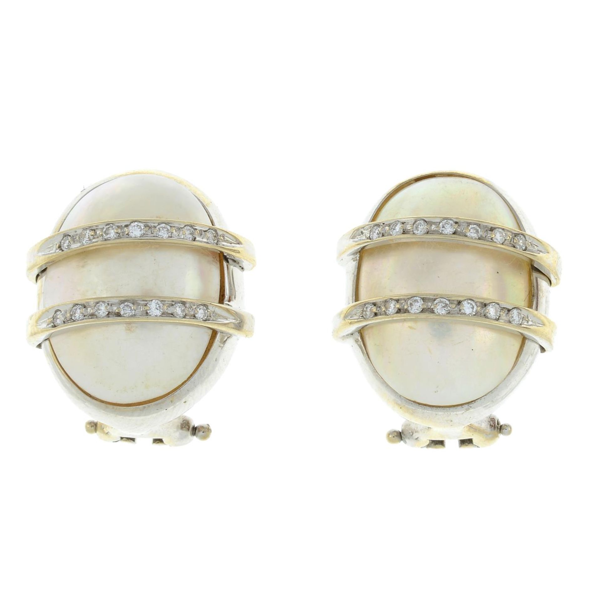 A pair of mabe pearl and diamond earrings.Estimated total diamond weight 0.15ct.