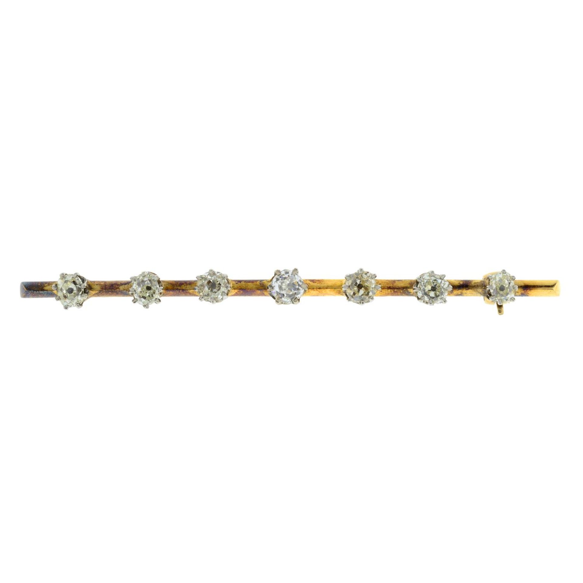 An 18ct gold diamond bar brooch.Estimated total diamond weight 1.20cts,