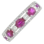 An 18ct gold ruby and diamond dress ring.Total ruby weight 0.89ct.