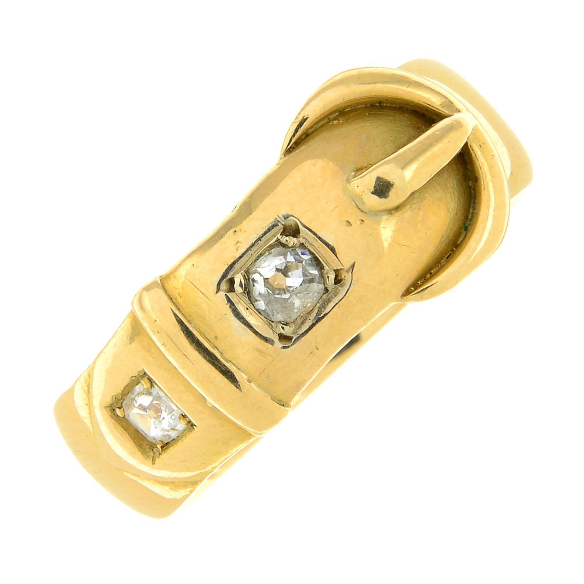 An 18ct gold old-cut diamond buckle ring.Estimated total diamond weight 0.25ct,