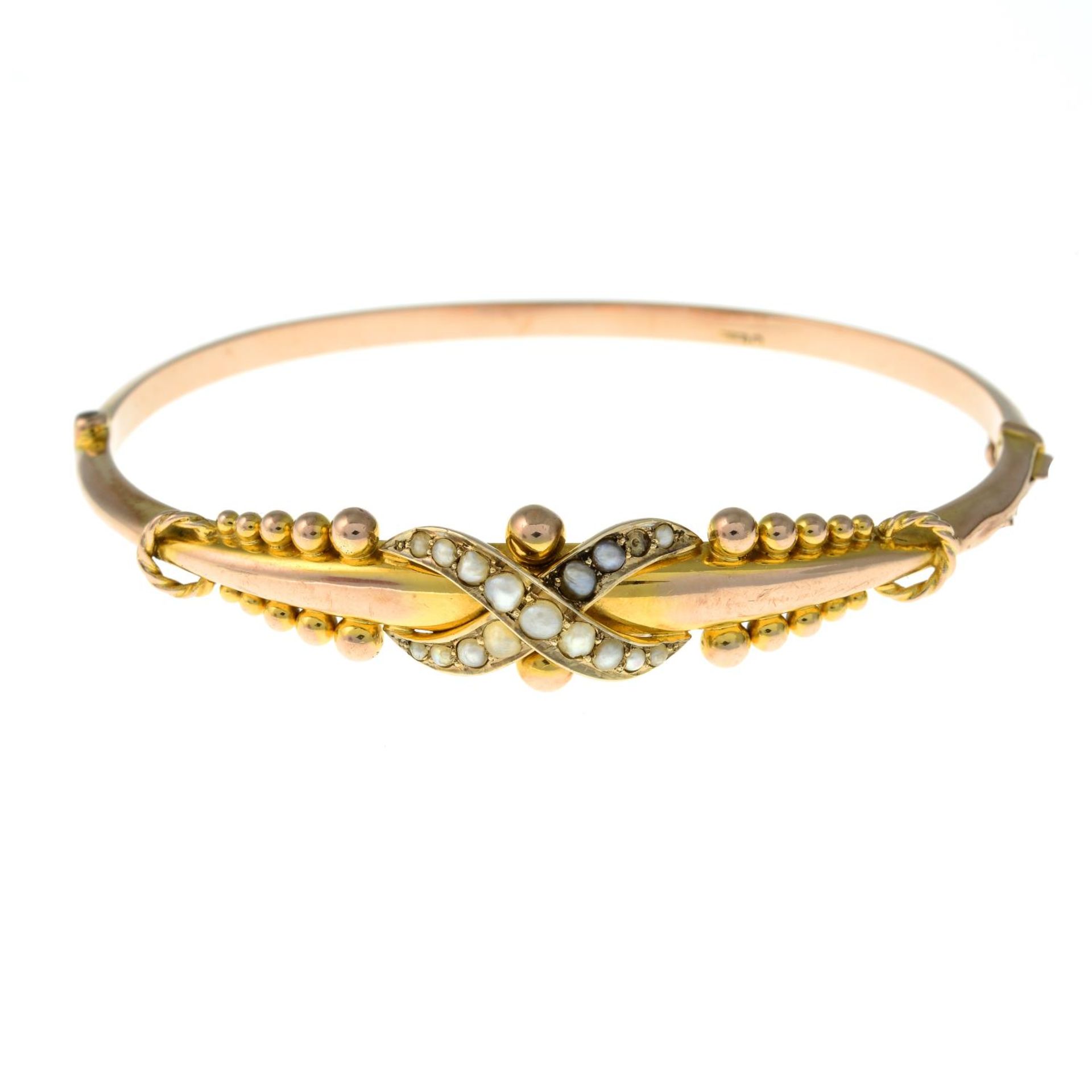 An early 20th century 9ct gold split pearl hinged bangle.Hallmarks for Chester,