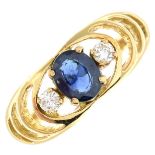 A sapphire and diamond three-stone ring.Estimated total diamond weight 0.10ct.Stamped 18.Ring size