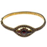 A garnet hinged bangle.Inner diameter 6cms.