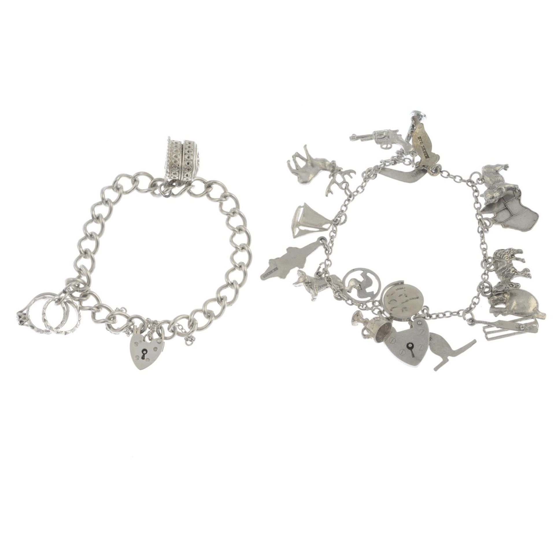 Two silver charm bracelets and a further charm bracelet.