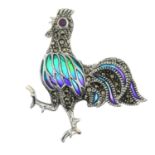 A plique-a-jour enamel rooster brooch with ruby and pyrite detail.May also be worn as a