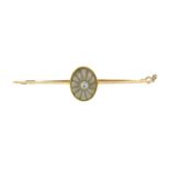 A 9ct gold carved rock quartz bar brooch with safety chain.