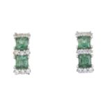 A pair of green cubic zirconia and colourless gem earrings.Green cubic zirconia's each with