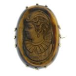 A selection of Victorian and later brooches, to include a carved tigers eye cameo brooch.