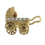 A 9ct gold cubic zirconia pram and baby charm.Hallmarks for London.Length 2.4cms.