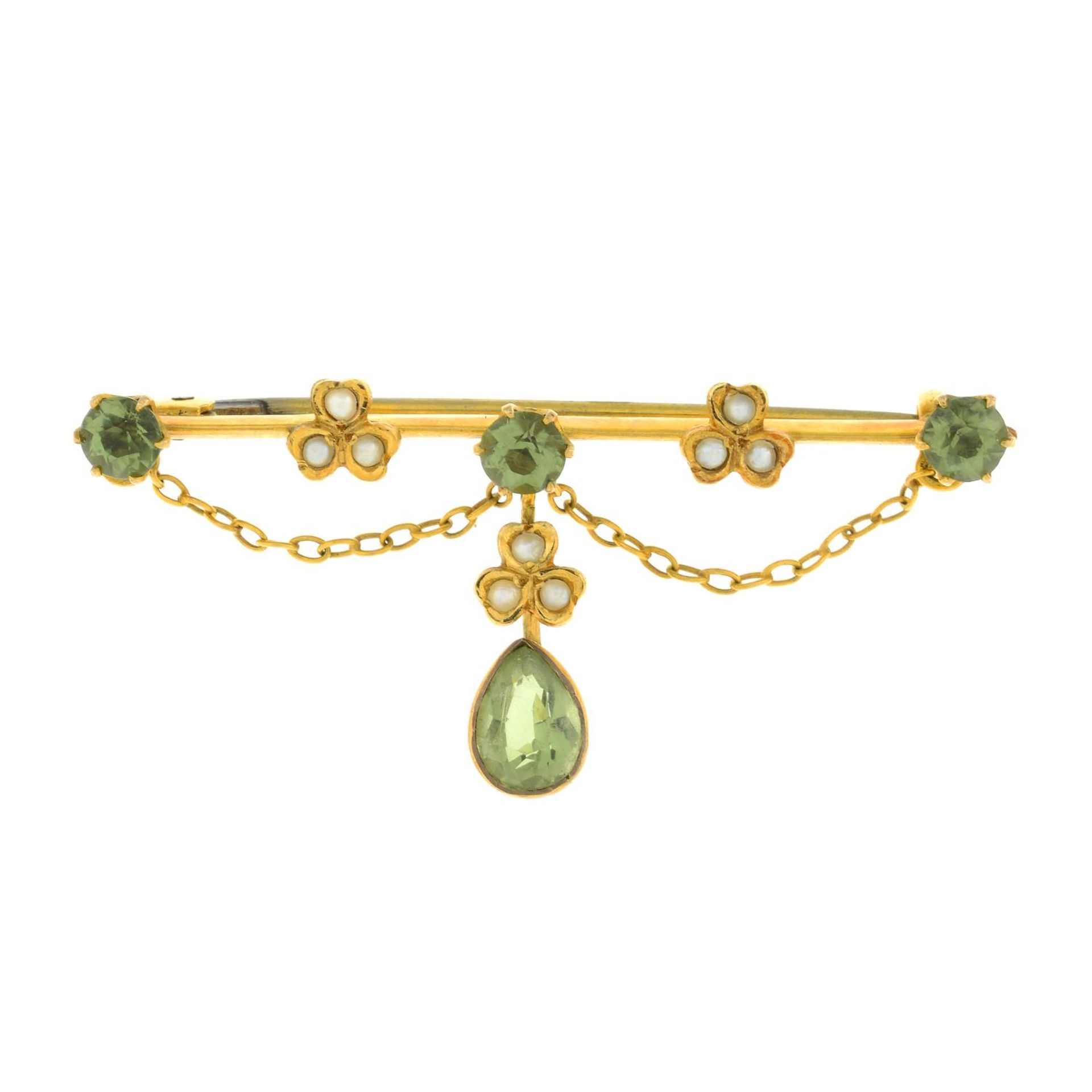 An Edwardian peridot and split pearl brooch.