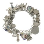 Three silver charm bracelets together with a further charm bracelet and an assortment of charms.