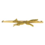 An early 20th century 15ct gold bar brooch, depicting a running fox.Stamped 15CT.