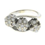 An 18ct gold diamond triple cluster ring.Two stones deficient.