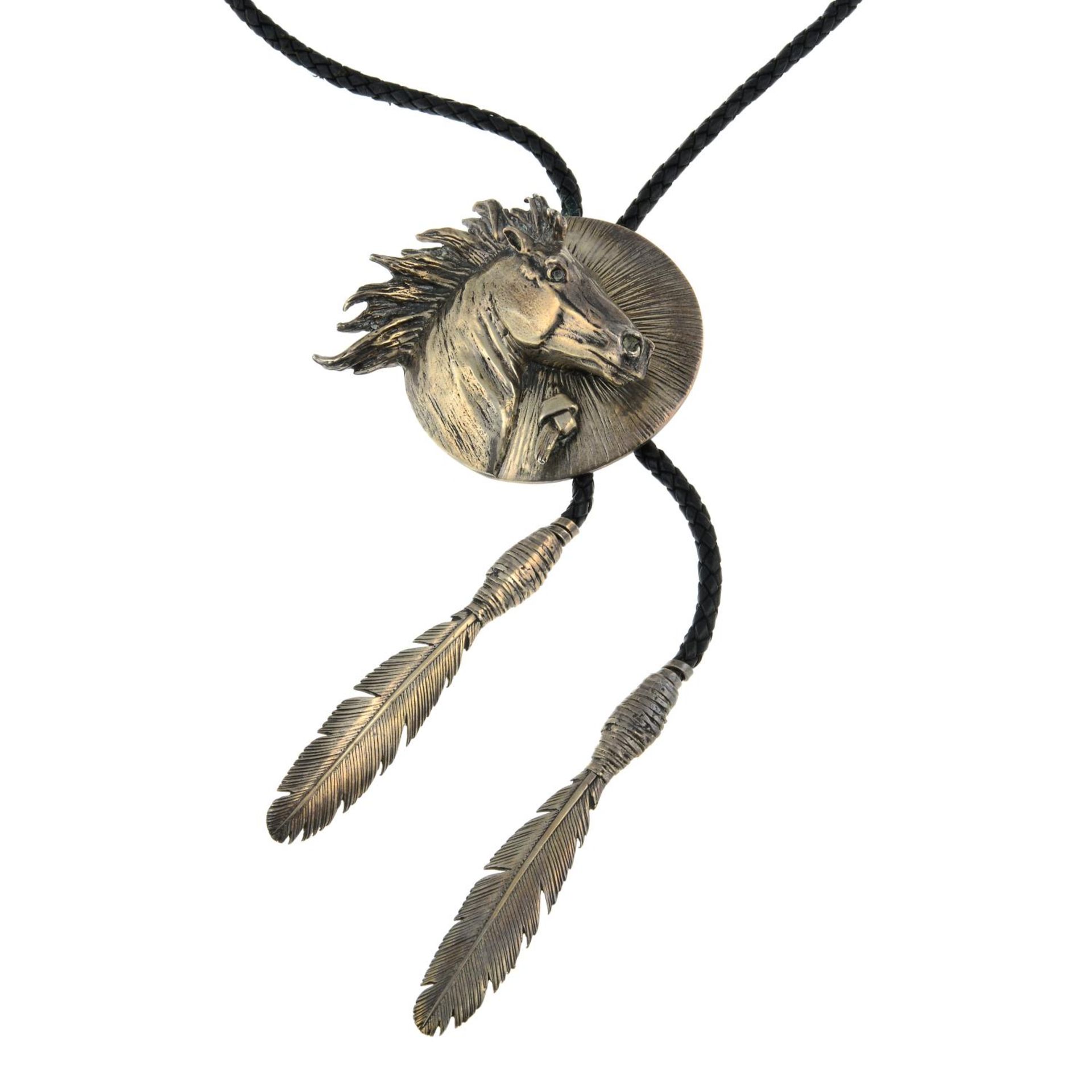 A leather cord necklace with horse and feather motif, by Stan Bentall.