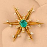 A Colombian emerald and diamond star clip brooch.