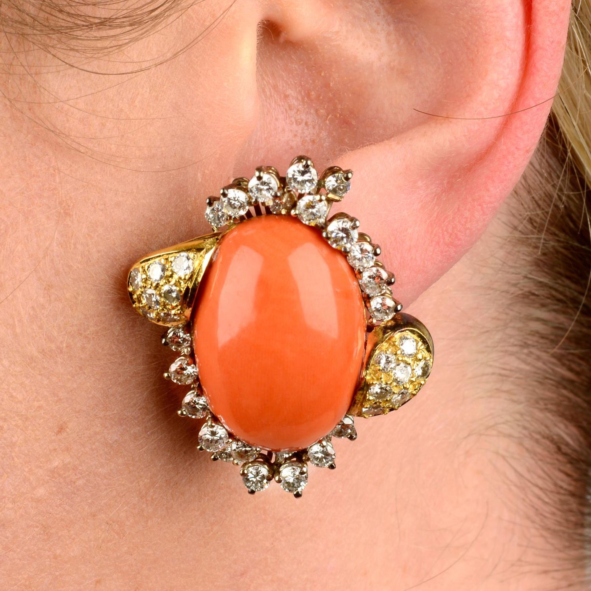 A pair of coral and diamond earrings.Estimated total diamond weight 4cts,