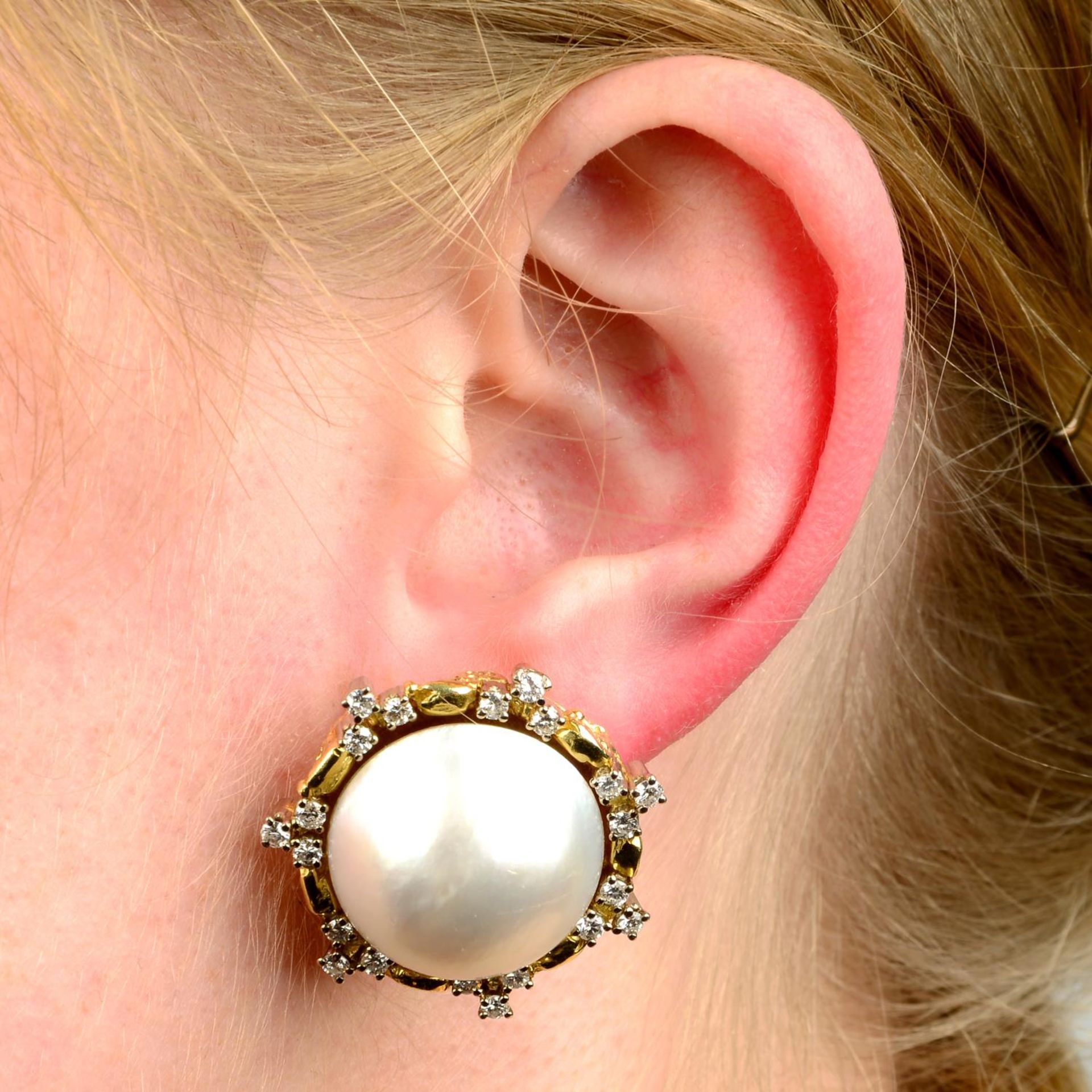 A pair of mabé pearl and diamond earrings.