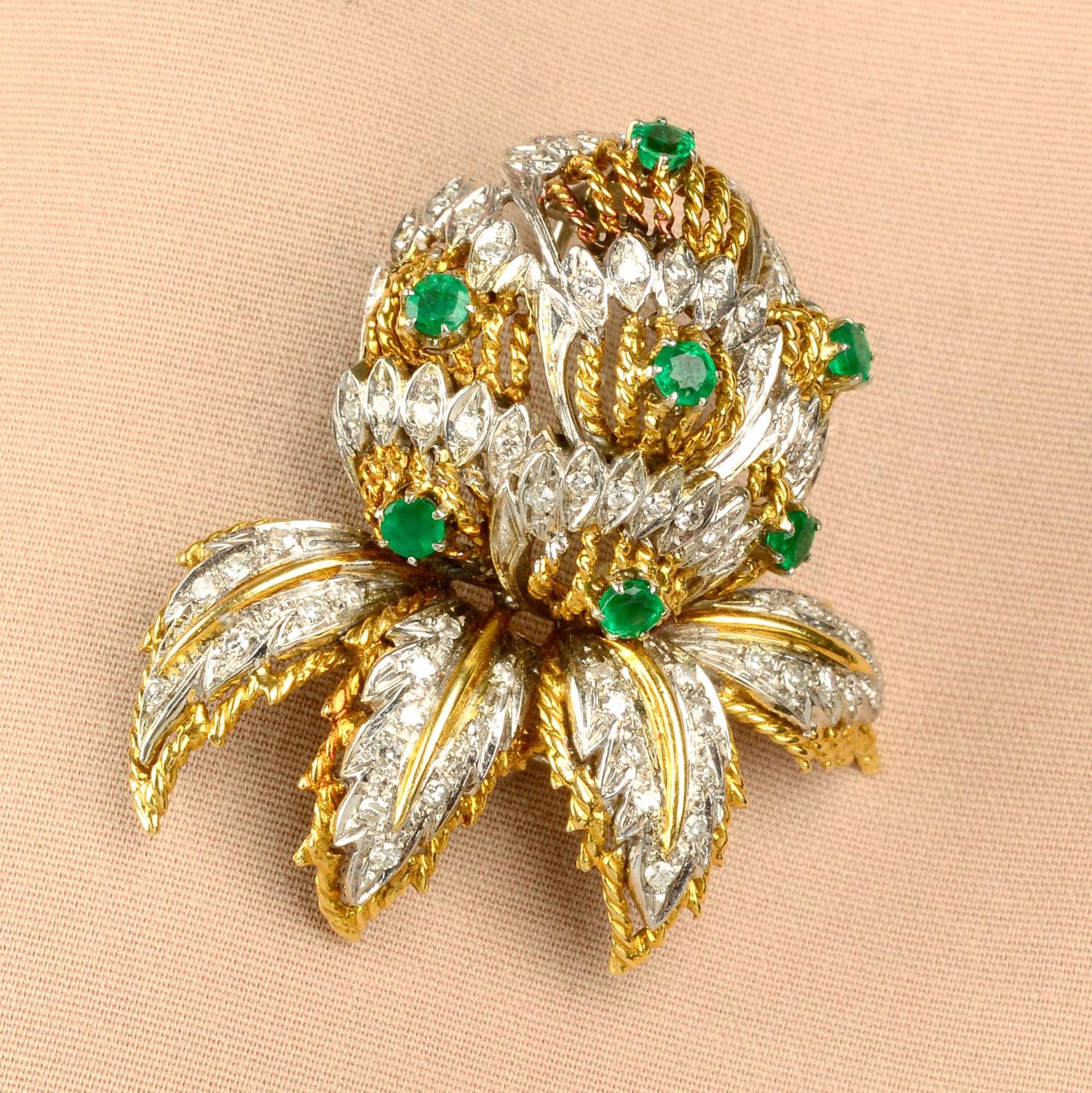 A 1970s 18ct gold emerald and diamond floral brooch.