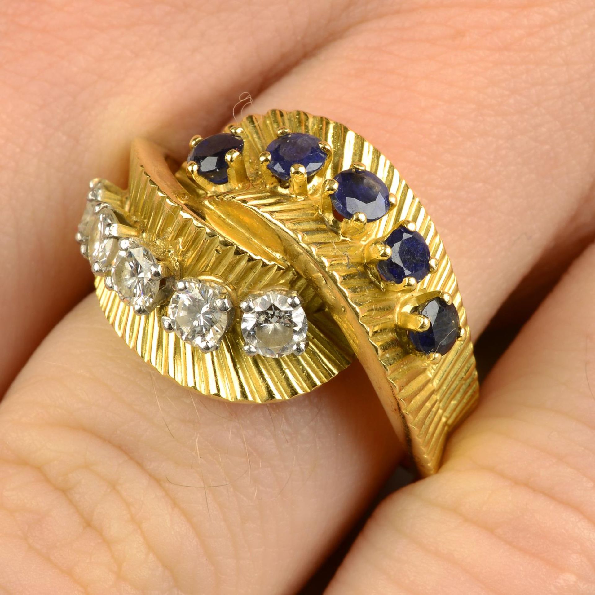 A 1960s sapphire and diamond crossover dress ring.Estimated total diamond weight 0.60ct, - Image 4 of 8