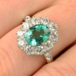 An emerald and diamond cluster ring.